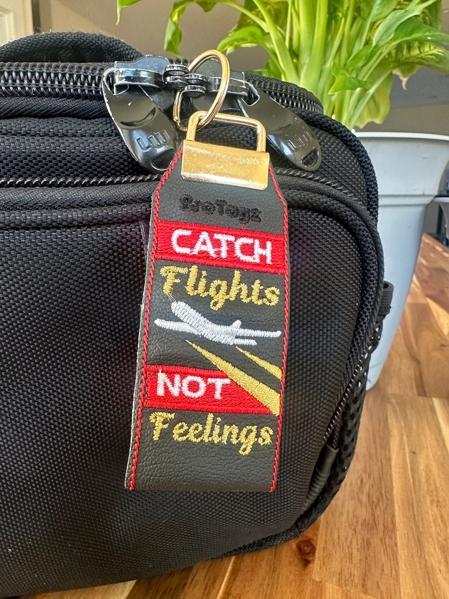 “Catch Flights Not Feelings” Keychain Fob